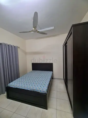 Dark wooden queen size bed with mattress and matching wardrobe