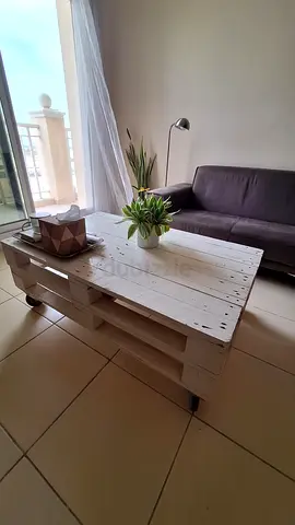 White rustic coffee table on casters