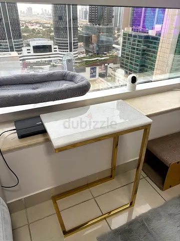 White marble-top C-shaped side table with gold frame