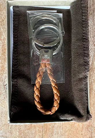 Christofle Duo Complice Rhodium Silver Plated Key Chain with Braided Caramel Colored Leather.