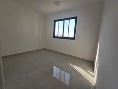 Two bedrooms and a living room in Al Hamidiya, brand new building, first occupancy, prime location c