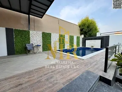 Luxury villa for sale in Al Muwaihat, Ajman, with a swimming pool, priced inclusive of electricity, water, and air conditioning. A unique opportunity