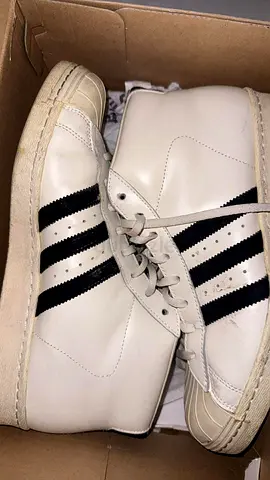 White high-top sneakers with black stripes