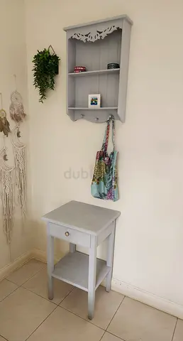 Light grey wall shelf with hooks and matching bedside table