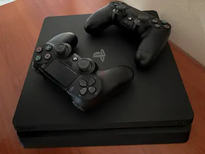 PS4 Slim 1TB , 2 Original Controllers      Perfect Condition