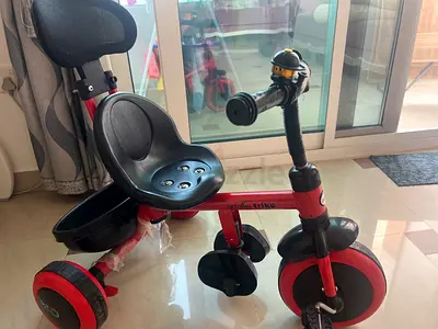 My toddlers red  black tricycle with parent handle and rear basket