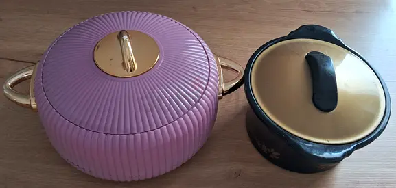 Two casserole pots — pink serving/insulated pot and black ceramic pot