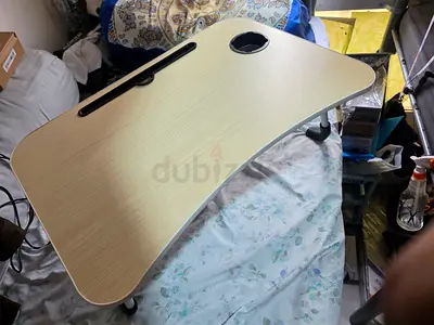 Portable adjustable laptop/bed table with cup holder and tablet slot