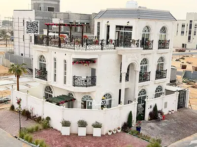 Luxury villa for sale in Al Bahia area, featuring two floors and a rooftop terrace. Modern design, spacious living areas, reception halls, and compreh