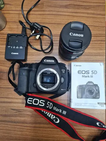 Canon EOS 5D Mark III DSLR body with EF lens, charger and strap