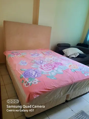 Upholstered bed with mattress and headboard (used)