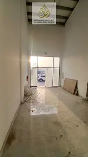 A commercial shop is available for annual rent in Al Rashidiya 1, located directly on the main road