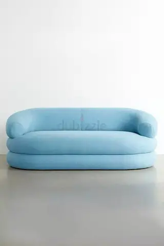 Light blue curved 2-seater sofa — gently used