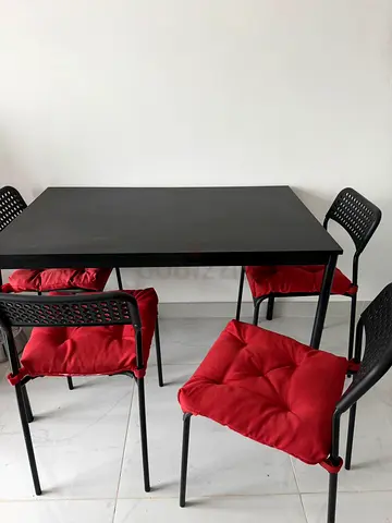 My black dining set — table + 4 chairs with red cushions