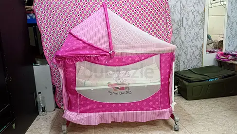 Pink bassinet/cradle with canopy and wheels