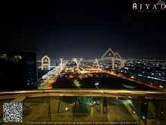 Annual rent: 2BR hall in Conquer Tower Ajman, 3 baths, central AC, 2 balconies, built-in wardrobes,