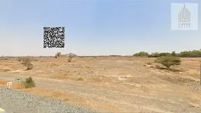 Residential land in Manama 8, behind the school