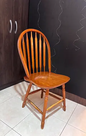 Used solid wooden spindle-back dining chair, similar to an antique piece