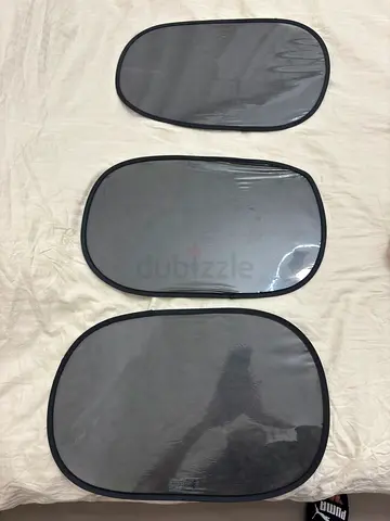 Set of three foldable sun shades for side and rear windows.