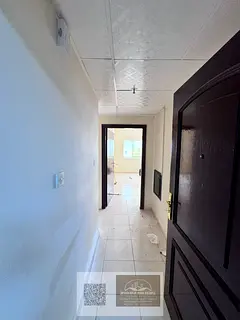 Spacious 1 Bedroom Apartment in Al Rumaila with Separate Living Room and Central AC