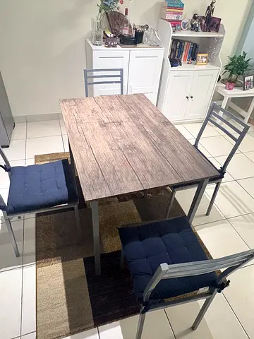 4-seater wooden-top dining table with metal frame and cushioned chairs