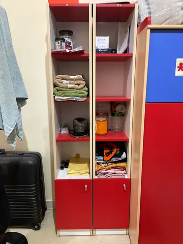 Pair of red tall shelved cabinets