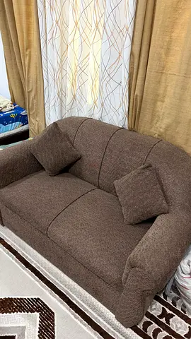 Brown 2-seater fabric sofa with cushions