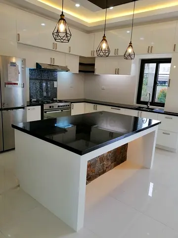 White kitchen island with black granite countertop