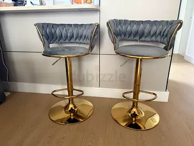 Pair of grey tufted velvet adjustable bar stools with gold base