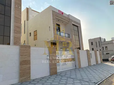 Luxury villa for sale in Al Yasmin, two floors and a roof, elegant design, featuring 7 spacious bedrooms, price includes electricity, water and air co