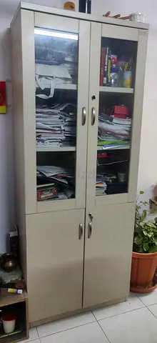 Light wood storage cabinet with glass display doors - used