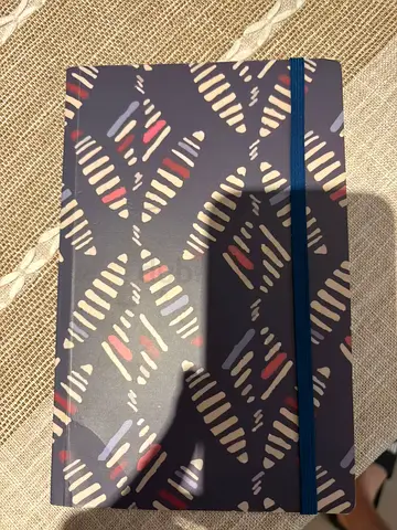 Lined notebook with elastic band and patterned cover