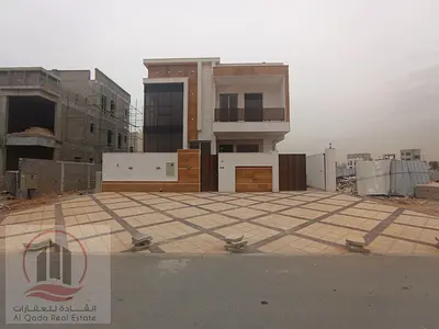 For sale, a villa in Ajman Al Helio, 6master rooms, a Majles room, a hall, and a maid’s room, freehold for all nationalities Includes fees and air co