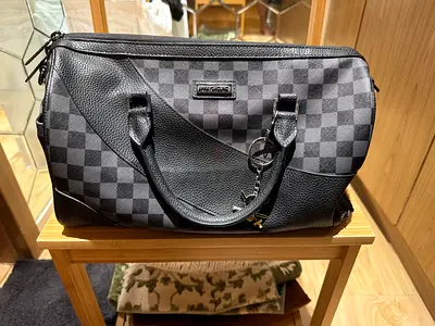 Black  grey checkered duffel bag — gently used
