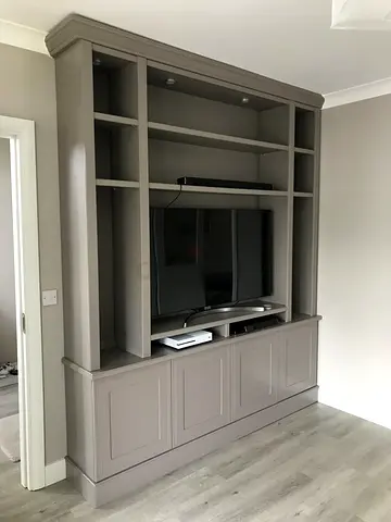 New wooden entertainment center with shelves and cupboards