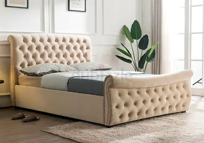Beige tufted upholstered bed frame with headboard and footboard