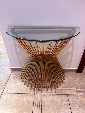 Round glass-top side table with gold metal base