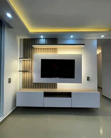 Modern wall-mounted TV unit with floating cabinets and LED lighting