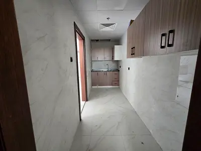 Brand new studio apartment, first occupancy, in Al Muwaihat, near the Academy, on Mohammed Bin Zayed exit, central air conditioning, maintenance inclu