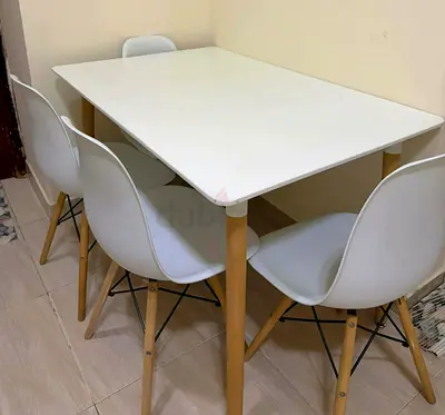 White Scandinavian-style dining table with 4 chairs