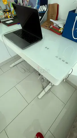 White glass-top electric smart work desk with inbuilt speakers, Bluetooth and wireless charging