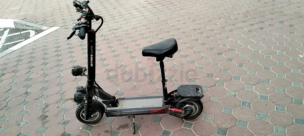 Used electric scooter with seat — working condition, visible wear
