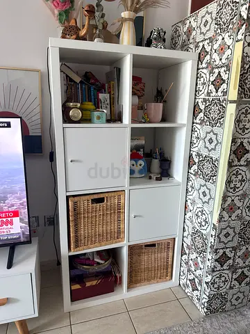 White 8-cube shelving unit with drawers and wicker baskets