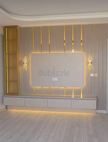 Wall-mounted TV entertainment unit with LED lighting and storage