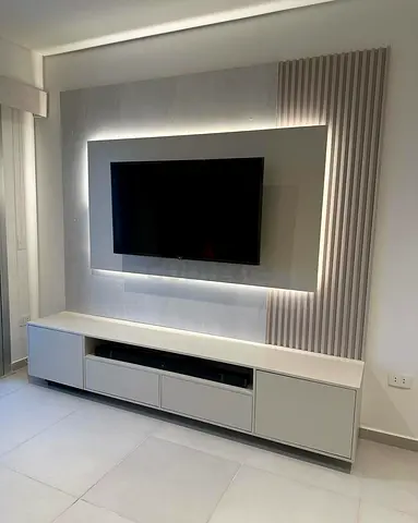 White TV entertainment unit with LED backlit panel and storage