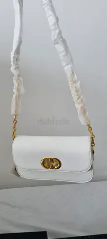 White leather crossbody bag with gold chain strap