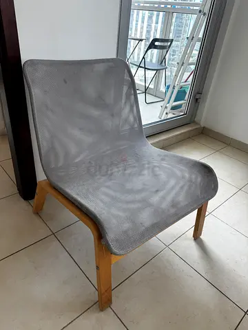 Grey mesh lounge chair with wooden bentwood frame