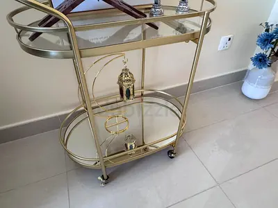 Gold two-tier glass cart on wheels