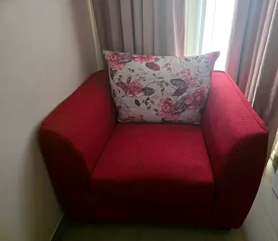 Red fabric single-seater armchair (includes floral cushion)