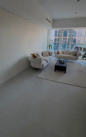 Two cream curved sofas